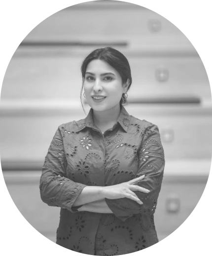Portrait of Maryam Maralani, smiling with her arms crossed